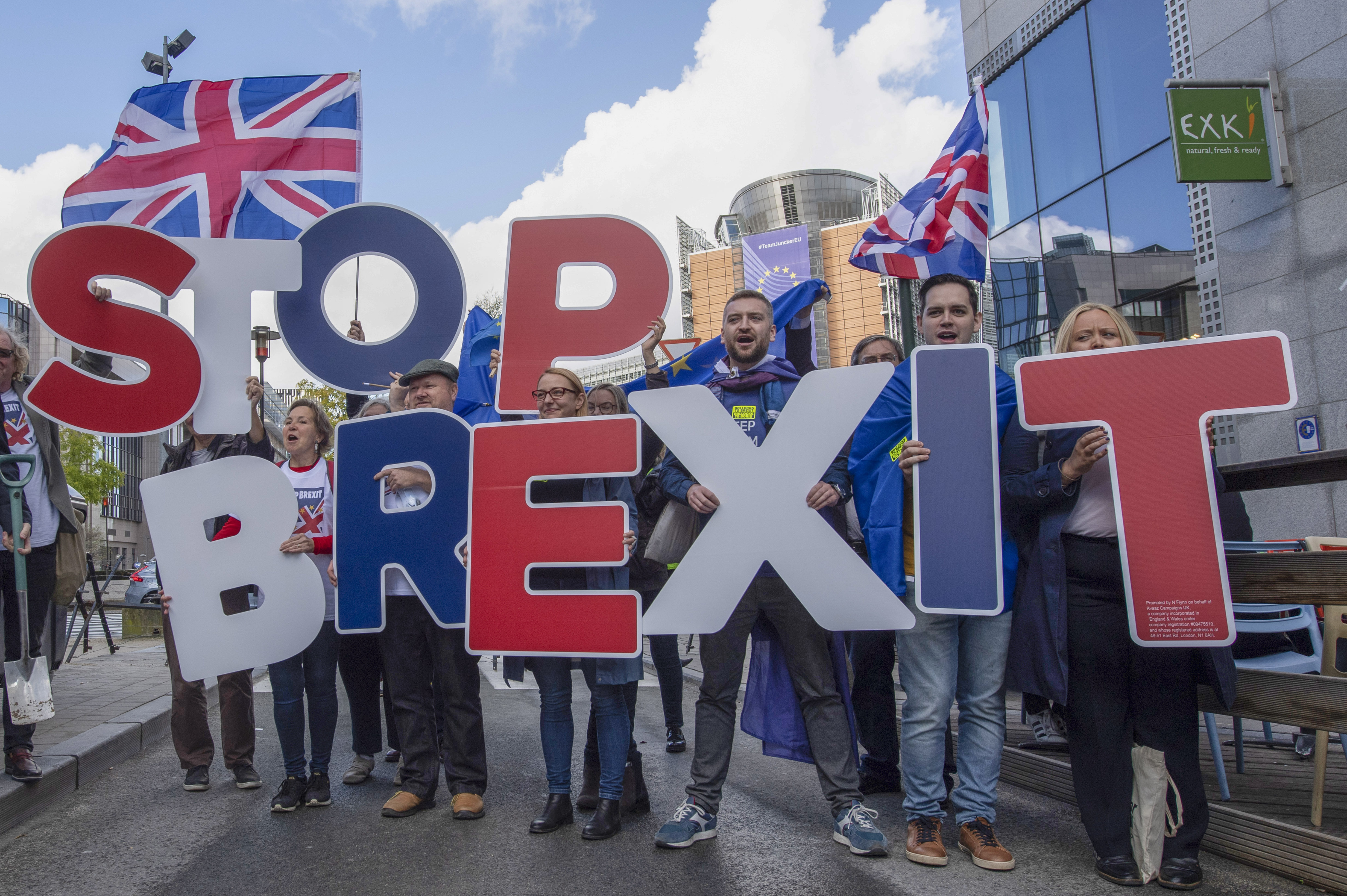 Young people demonstrating with signs "Stop Brexit"