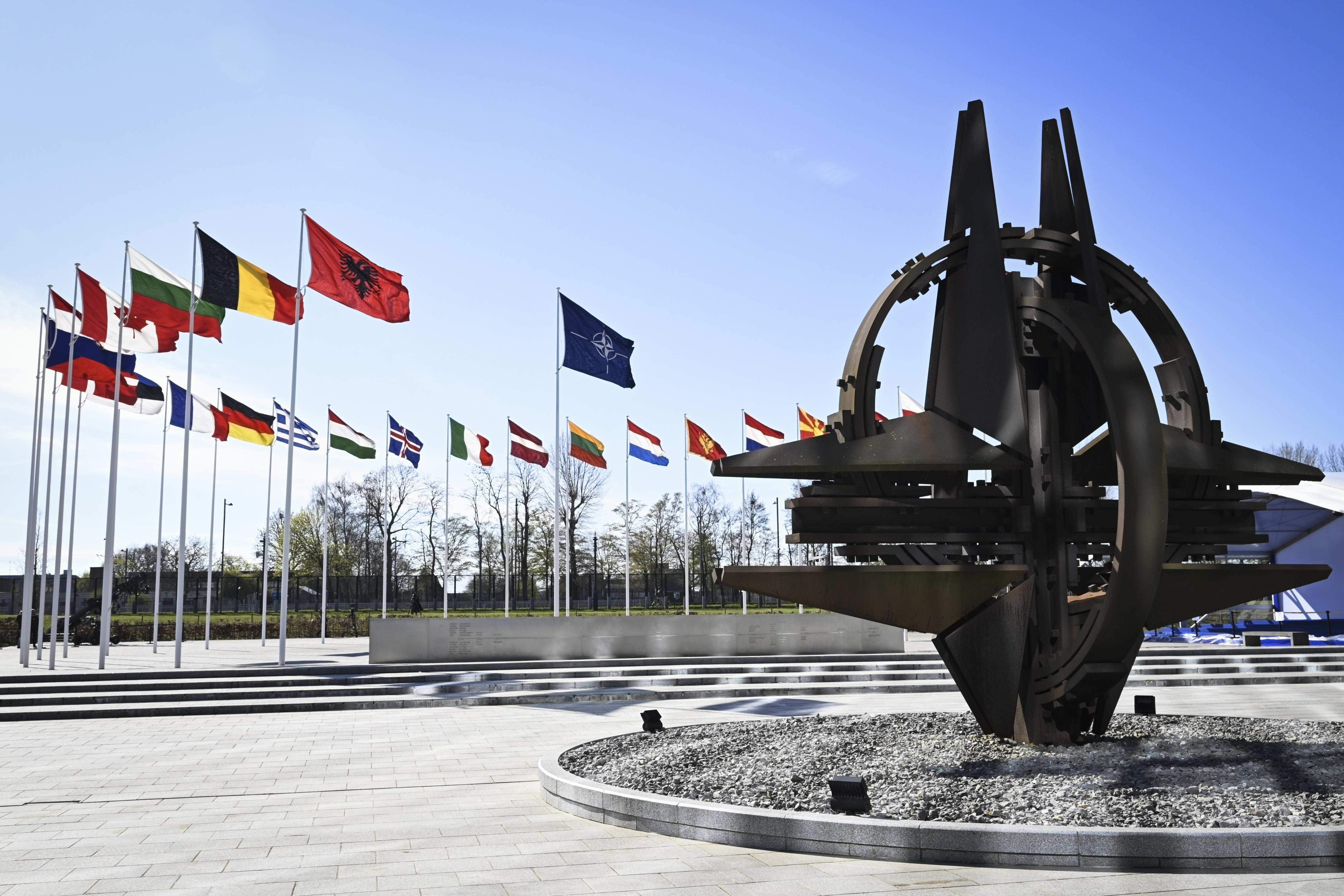 Eine Skulptur und Fahnen vor dem NATO-Hauptquartier in Brüssel, Belgien