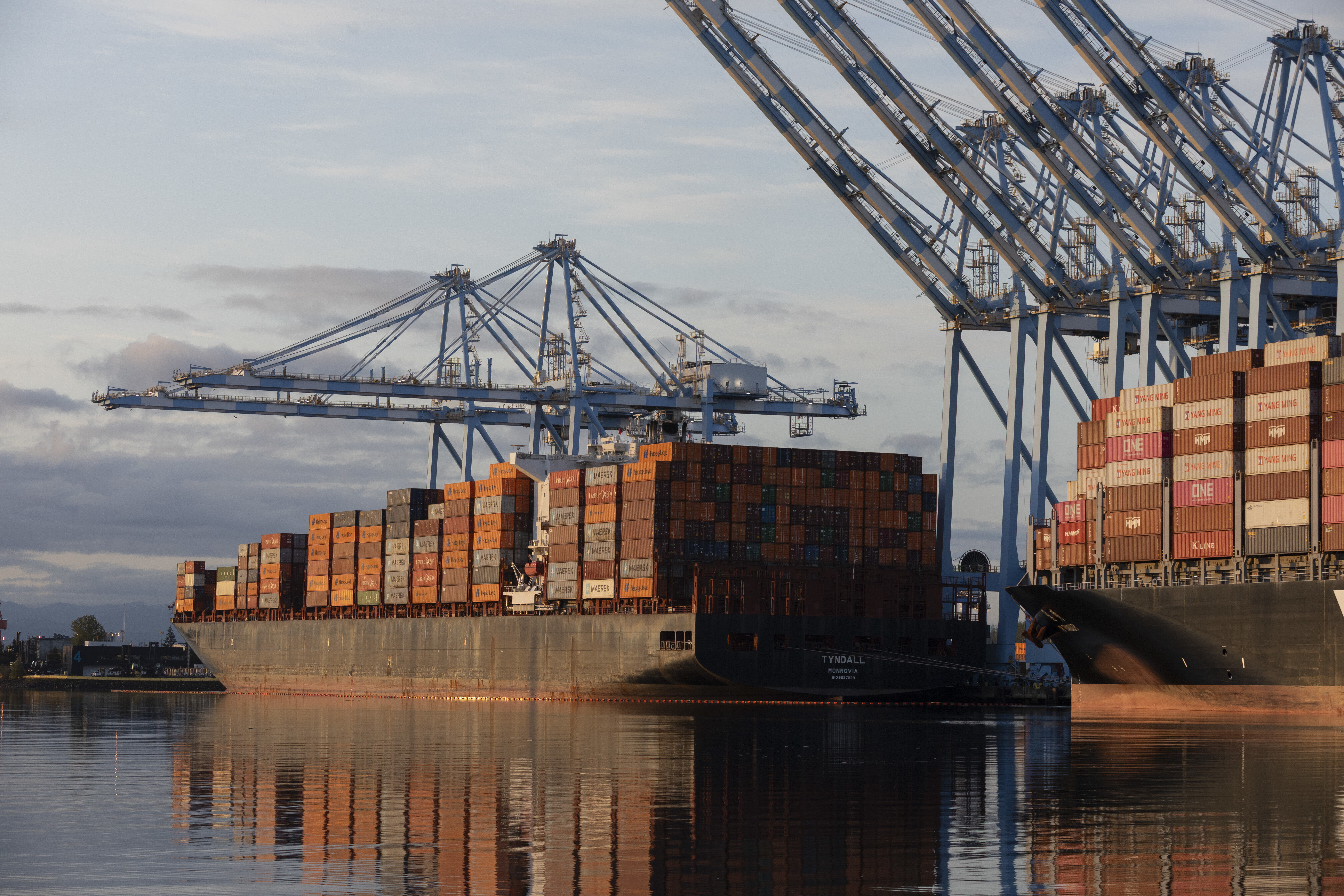 The sun rises over container ships