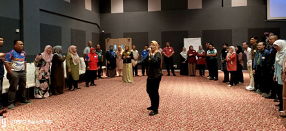 Participants of GMM's Leadership Training forming a circle around a trainer standing in the middle