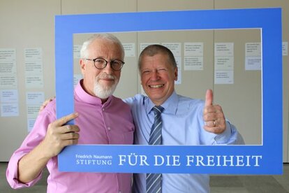 Stefan Melnik, the moderator, and Dr. Rainer Adam, FNF ESEE Regional Director