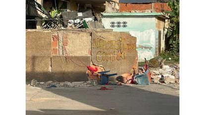 Graffiti across the streets of Venezuela reads "SOS: send food"
