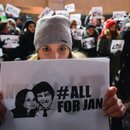 People hold a candle-lit vigil in front of the Consulate General of the Slovak Republic in Krakow, in memory of the journalist Jan Kuciak and and his fiancee Martina Kusnirova,