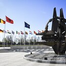 A sculpture and flags in front of the NATO headquarters in Brussels, Belgium.