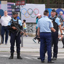 Before the Summer Olympics in Paris: Police officers stand guard in a street in Paris. 