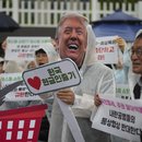 South Korea's government is very accommodating to US President Donald Trump - too much so, according to these demonstrators in Seoul.
