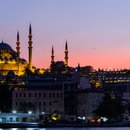 Istanbul Cityscape With Suleymaniye Mosque With Tourist Ships Floating At Bosphorus At Night