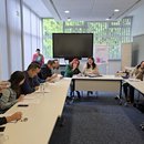 Three groups role-playing in negotiation and coalition-building: green youth group (left), NGO (middle) and liberal party (right)