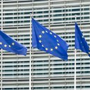 Drei Fahnen der Europäischen Union wehen vor dem Gebäude der EU-Kommission. 