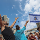 Crowds gather in Hostages Square, waving Israeli and American flags and celebrating the ceasefire agreement.