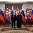 Vladimir Putin and Kim Jong Un in front of Russian and North Korean flags.