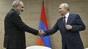 Russian President Vladimir Putin, right, and Armenian Prime Minister Nikol Pashinyan shakes hands during their meeting in the resort city of Sochi, Russia