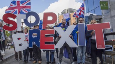 Young people demonstrating with signs "Stop Brexit"
