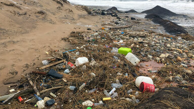 Angespülter Plastikmüll, Holz und Fässer liegen am Strand der Nordsee im Gebiet des Nationalparks Thy