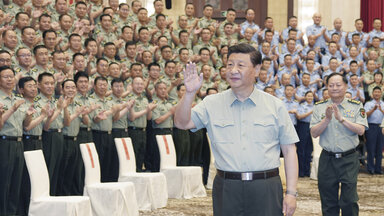 Xi Jinping in military attire greeting soldiers
