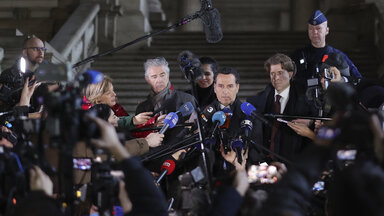 Lawyers for former European Parliament Vice-President Eva Kaili, Michalis Dimitrakopoulos, center right, and Andre Risopoulos, center left, speak with the media at the courthouse in Brussels, Thursday