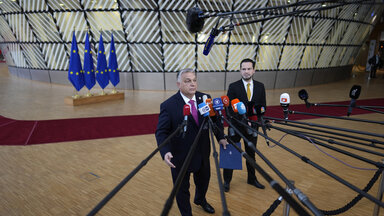 Hungary's Prime Minister Viktor Orban speaks with the media as he arrives for an EU summit at the European Council building in Brussels
