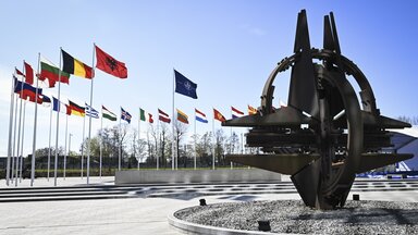 Eine Skulptur und Fahnen vor dem NATO-Hauptquartier in Brüssel, Belgien