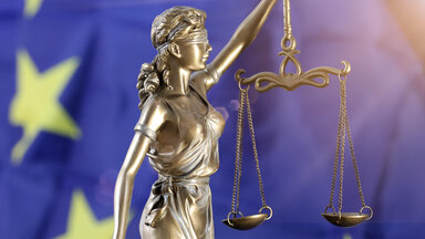 Justitia vor einer Europa-Flagge 