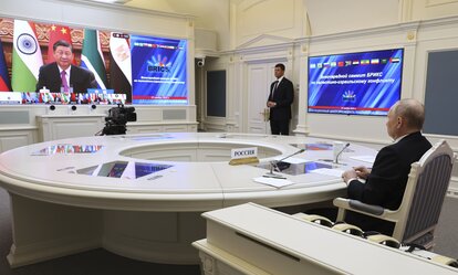 Russian President Vladimir Putin takes part in an extraordinary BRICS summit via video conference, while China's President Xi Jinping can be seen on the screen.